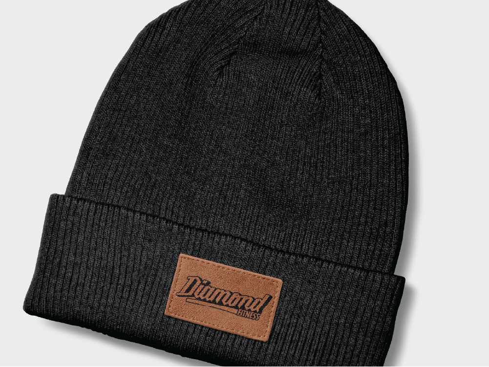 Close-up of a Diamond Fitness branded knit beanie with a leather patch logo, reflecting the brand’s merchandise and style.